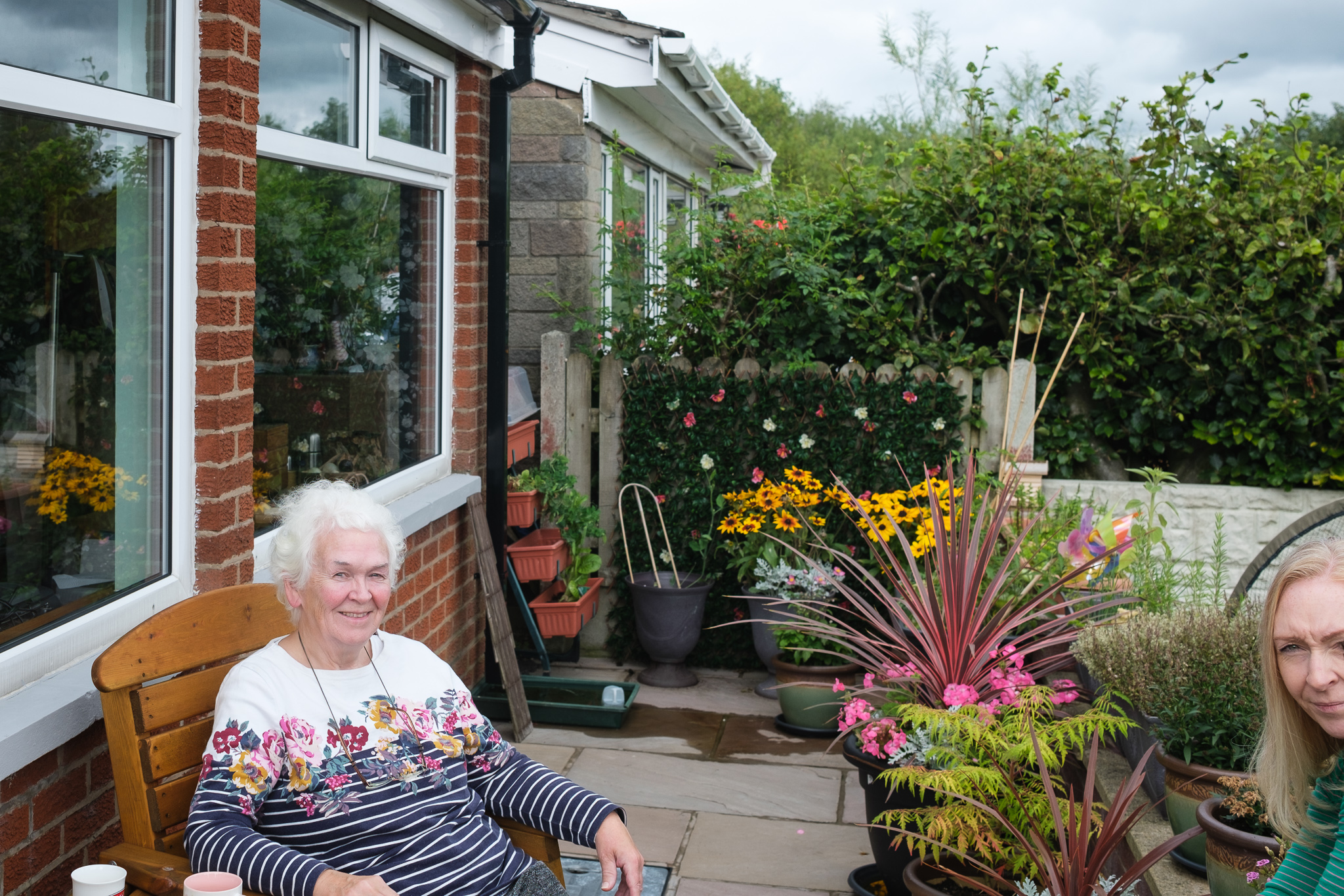 Mother sitting in back garden